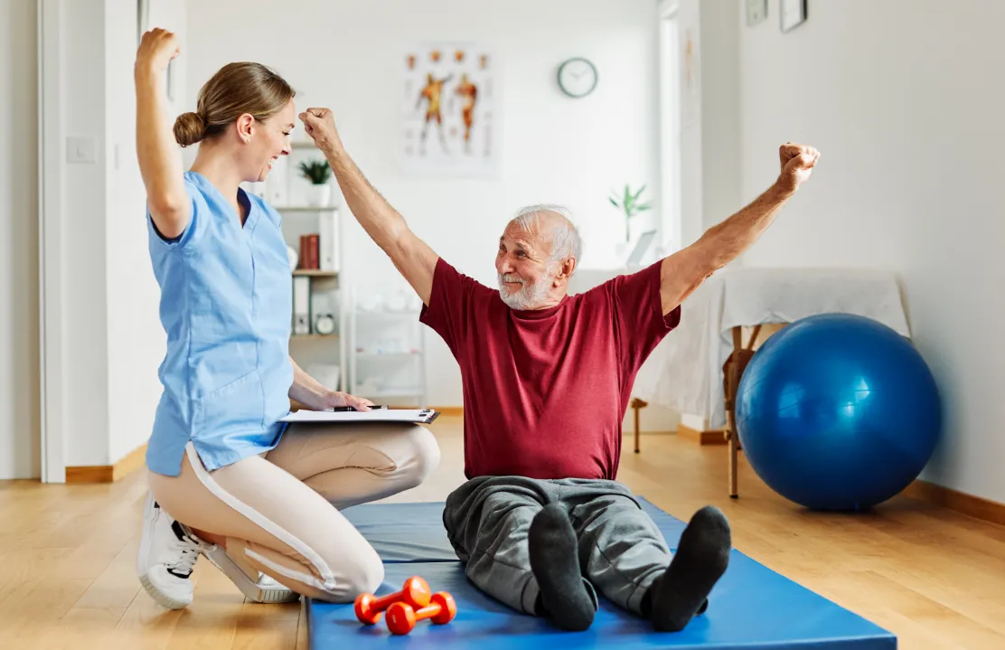 Work injury rehab: Patient on mat improving mobility. Physical therapy for pain relief & faster recovery at our rehabilitation clinic.