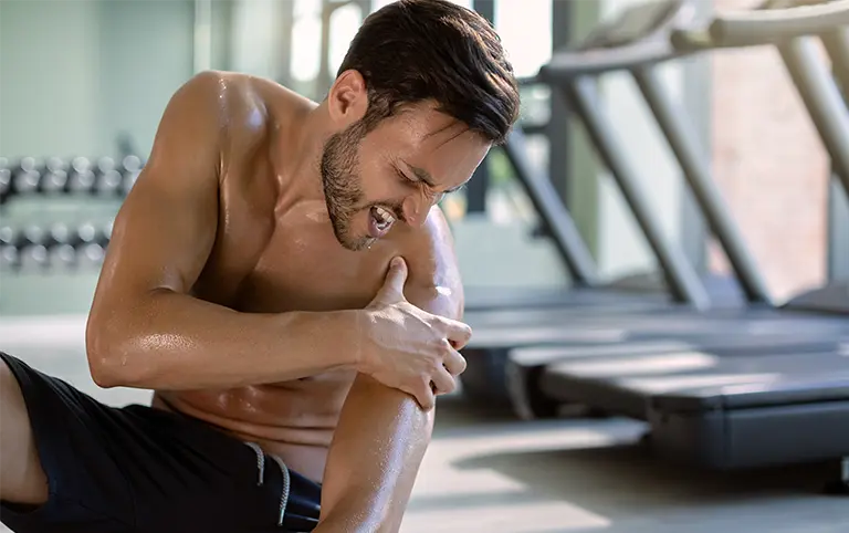 Shoulder Pain: Knee hold for pain relief. Physical therapy rehab treatment at our clinic for mobility recovery after work injury.